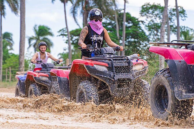 Riding ATVs through muddy trails